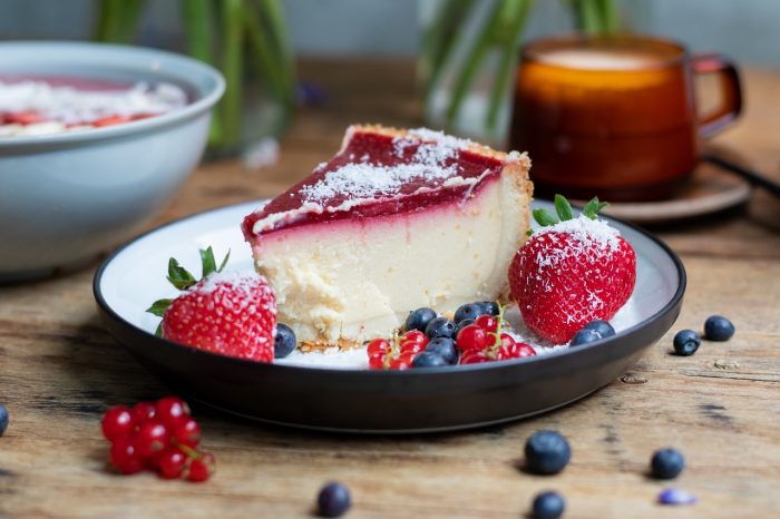 Closeup shot of cheesecake with jelly decorated with strawberries and berries