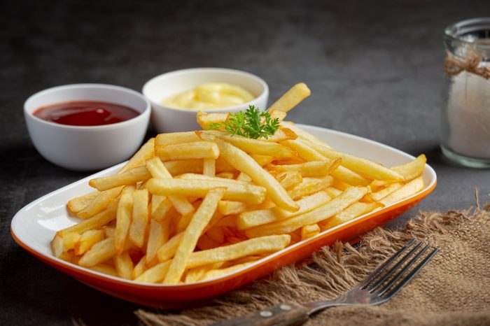 Crispy French fries with ketchup and mayonnaise.