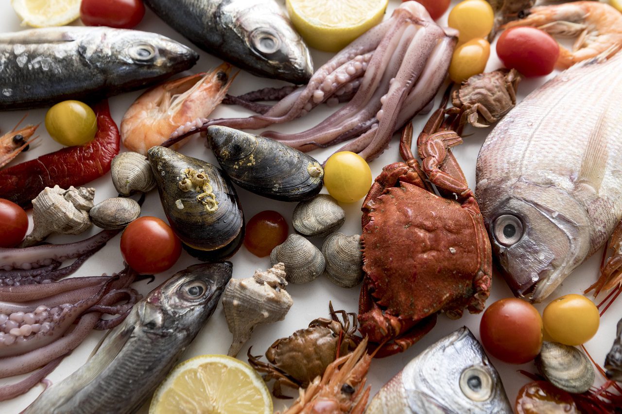 top-view-of-assortment-of-seafood-with-tomatoes